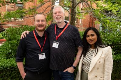 three people pose for picture